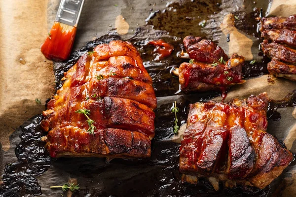 Grilled pork ribs on baking paper, top view. Copy space. — Stock Photo, Image