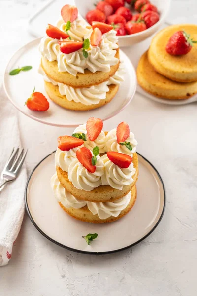 Strawberry cake with vanilla cream on white background. Copy space.