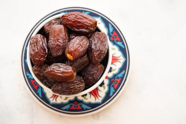 Fresh Medjool Dates in a bowl. Ramadan kareem. White background. Turkish style. Top view. Copy space. — Stock Photo, Image