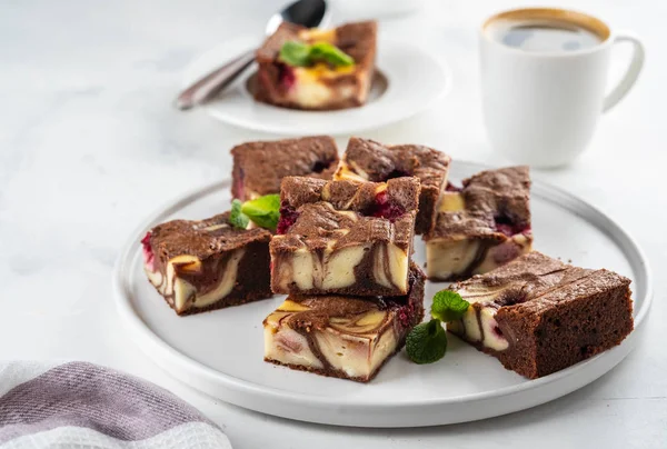 Cheesecake brownies with raspberry stacked on a white plate. — Stock Photo, Image