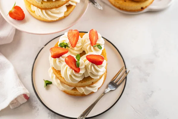 Strawberry cake with vanilla cream on white background. Copy space.