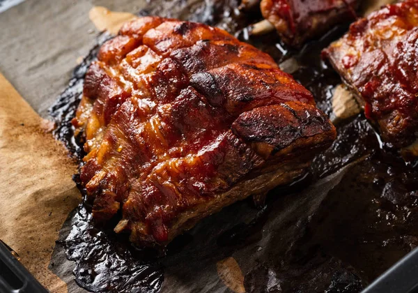 Grilled pork ribs on baking paper, top view. Copy space. — Stock Photo, Image