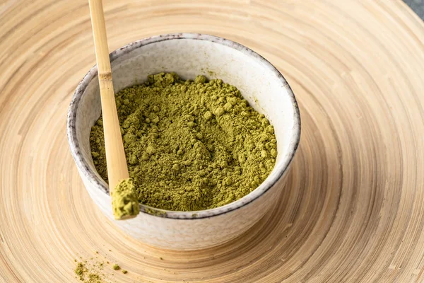 Japanese matcha green tea powder, a healthy natural product, antioxidant. Bamboo spoon and whisk.