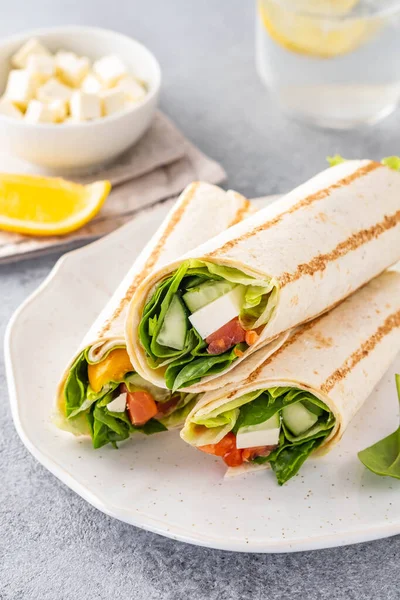 Wrap sandwich, roll with fish salmon, vegetables and cheese. Grey background. Close up. — Stock Photo, Image