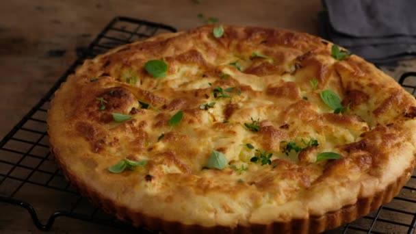 Greek cheese pie. Woman prepares a pie with feta cheese and microgreens. Black background. — Stock Video