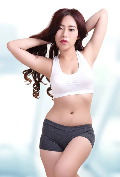 beautiful asian woman wearing fitness clothes in fitness center