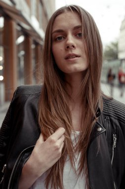 Siyah deri ceketli sarışın kadın portresi.