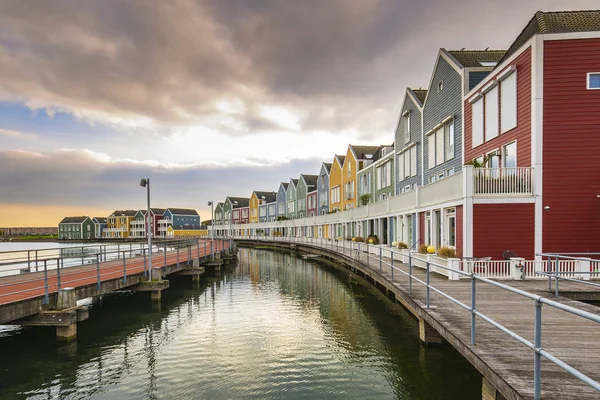 stock image Dutch, modern, colorful vinex architecture style houses at waterside during dramatic and clouded sunset. Houten, Utrecht.