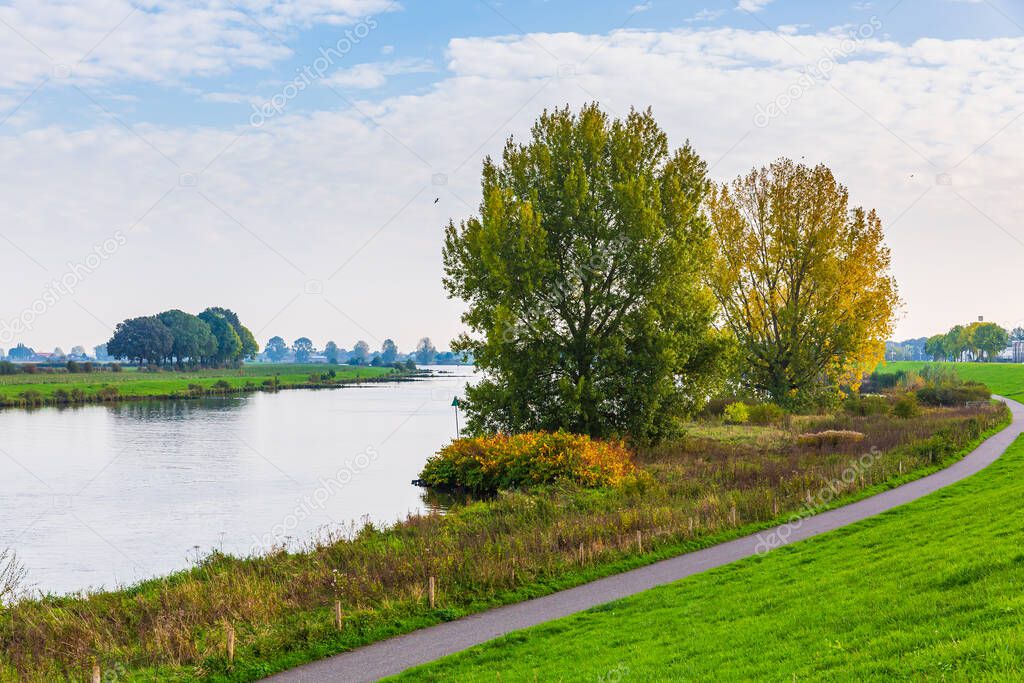 Land van Cuijk, agricultural landscape at the small village Cuijk and the Meuse river, the Netherlands under a blue sky. Popular touristic landmark for travel