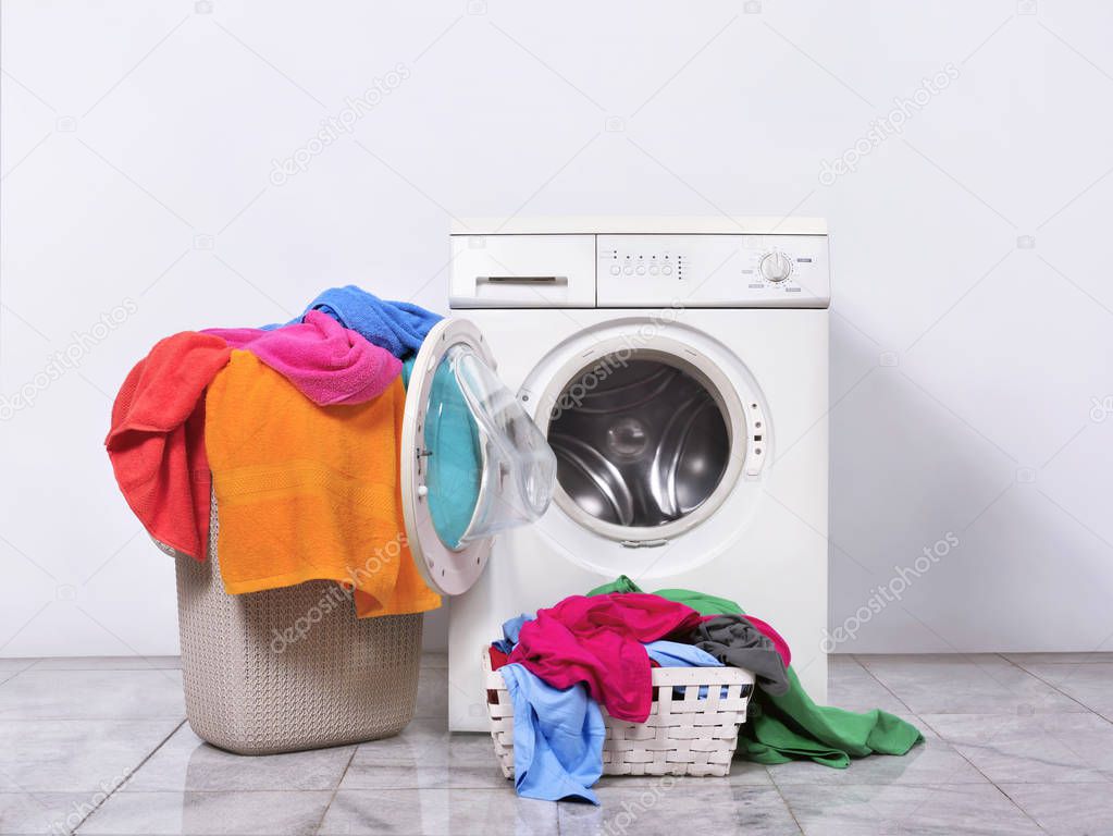 Laundry basket and washing machine at home. Home appliances