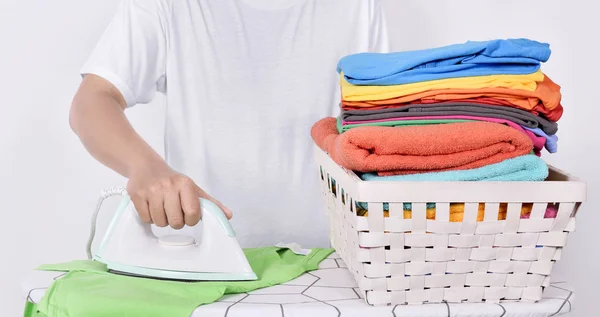 Man ironing clothes on ironing board isolated over white background