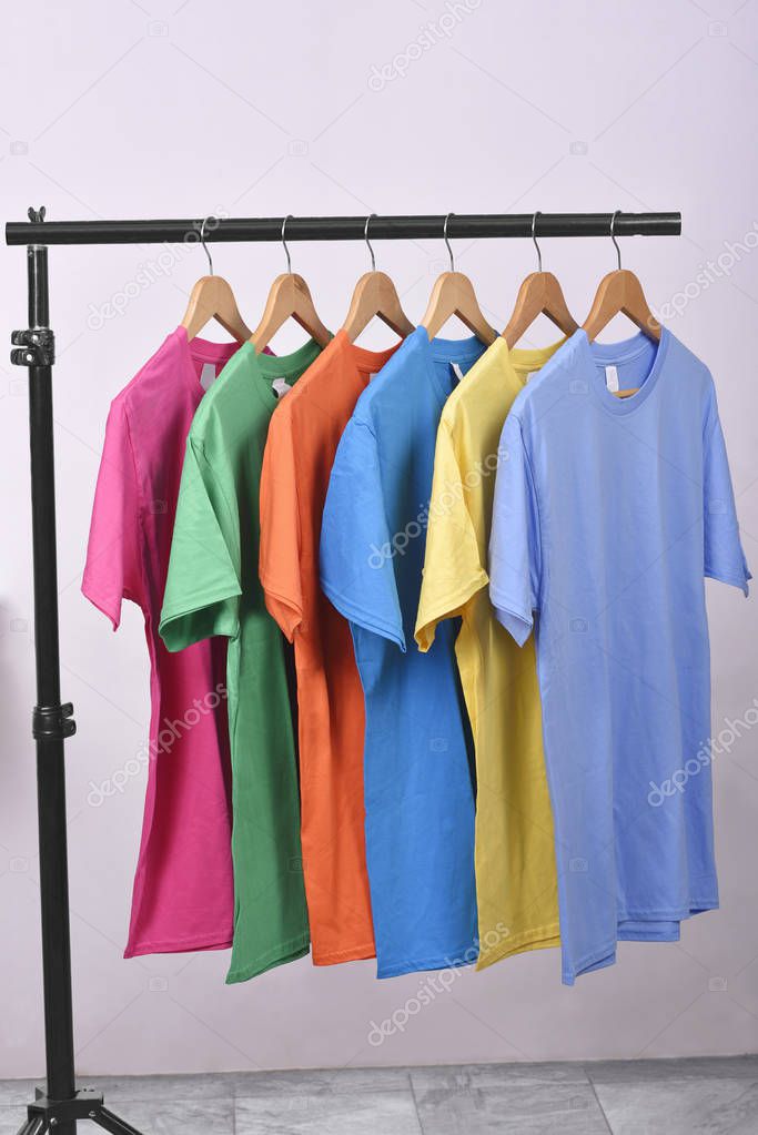 Colorful clothes with clothes hook on hang on a shelf home