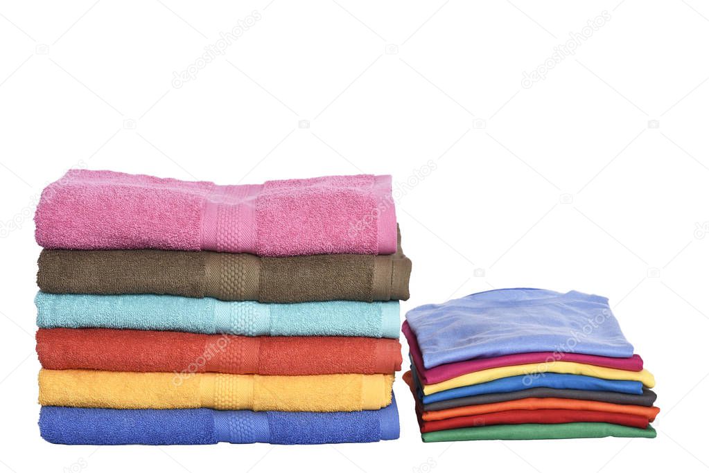 Pile of tidy clothes and folded towels isolated over white background