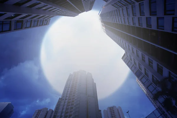 Skyscrapers building with dramatic full moon on the sky. Halloween background