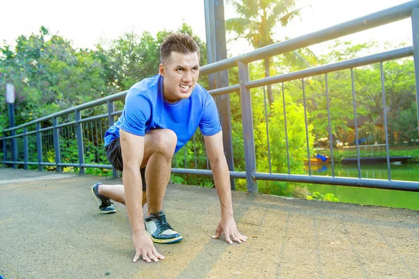 公園上で実行する準備ができている位置に若いアジア ランナー男 — ストック写真