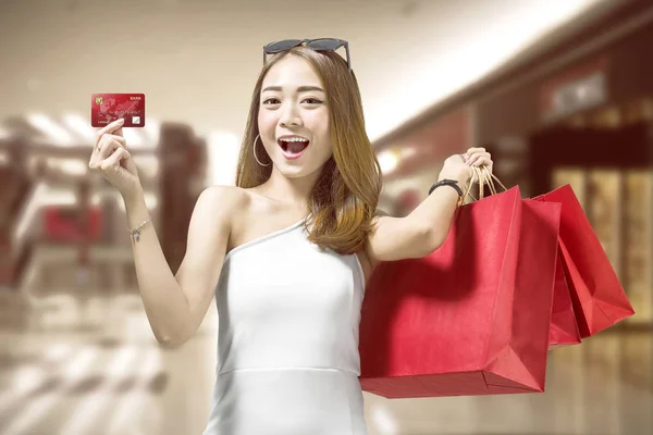 Alegre Asiático Mujer Con Rojo Compras Bolsas Mostrando Tarjeta Crédito — Foto de Stock