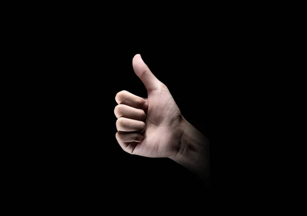 暗い背景上のジェスチャーを親指を示す手 — ストック写真
