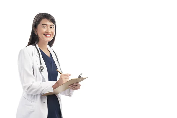 Schöne Asiatische Ärztin Mit Labormantel Schreibnotizen Auf Dem Klemmbrett Posiert — Stockfoto