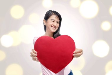 Kırmızı kalp kağıt ile duran güzel Asyalı kadın. Sevgililer günü