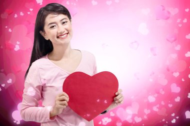 Kırmızı kalp şekli ellerinde tutan güzel Asyalı kadın. Sevgililer günü