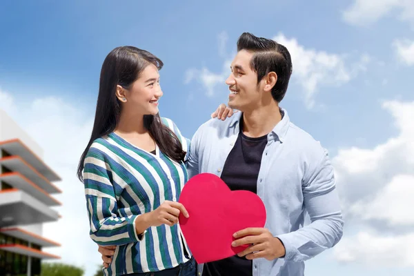 迷人的亚洲夫妇拥抱和持有红纸心脏在户外 爱情概念和情人节 — 图库照片