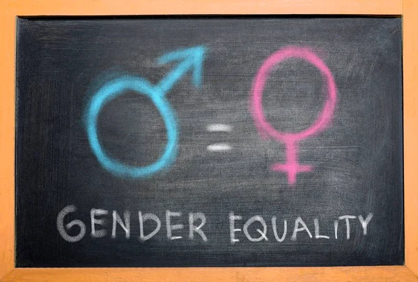 Symbol of male gender is equal to female gender on the blackboard. Equality gender concept