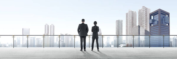 Rear view of two asian business people standing on modern terrac