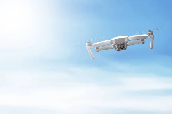 White drone with camera flying