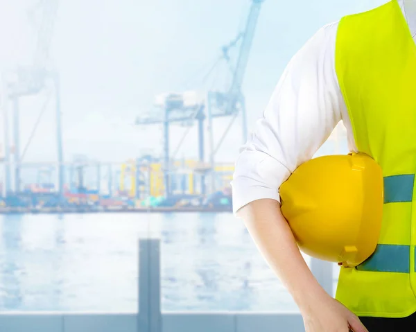 Travailleur masculin tenant le casque jaune sur ses bras sur l'abricot — Photo