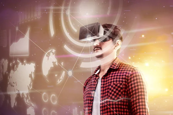 Asian man looking at digital interface with virtual reality device display the world map, graphic bar and binary code. Augmented reality technology