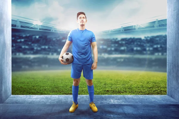 Asiatischer Fußballer hält den Ball in der Stadionhalle — Stockfoto