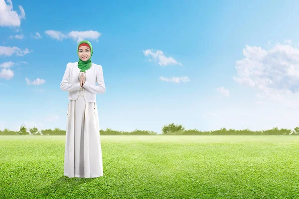 緑の草原で祈るベールのアジアのイスラム教徒の女性 — ストック写真