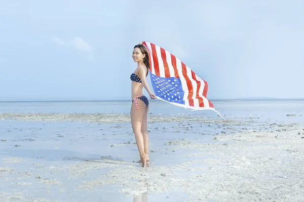Asian sexy girl in bikini of american flag holding a waving amer