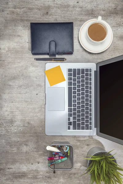 Top view of business desk with laptop, sticky notes, coffee, pot — Stock Photo, Image