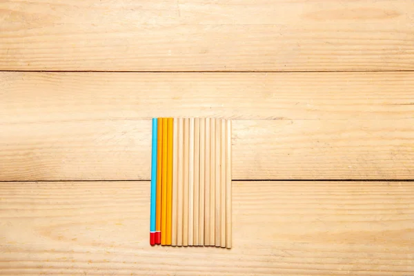 Row of stationery of pencils on the wooden table — Stock Photo, Image