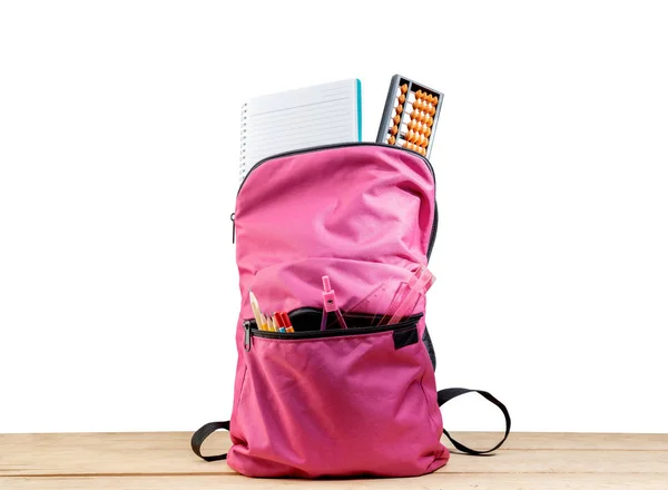 Pink hátizsák könyv és különböző írószerek a fából készült asztal — Stock Fotó