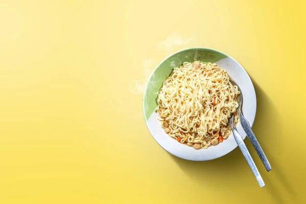 Noodles on the bowl with spoon and fork — Stock Photo, Image