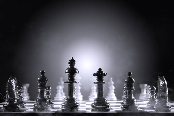 Whole group of white chess piece and black chess piece on the chessboard
