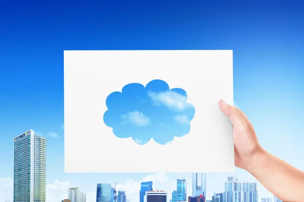 Hand holding the paper with a piece of cloud pattern — Stock Photo, Image