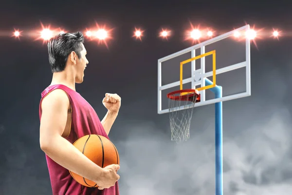 Rear view of Asian man basketball player holding the ball with a — Stock Photo, Image