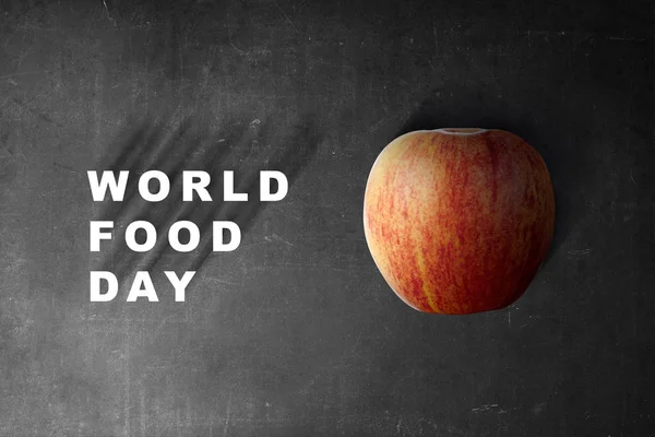 Apple fruit with World Food Day text on black background