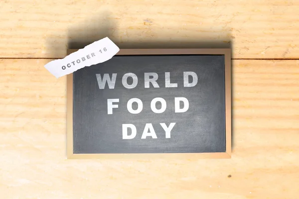 Chalkboard with World Food Day text and ripped paper with the da
