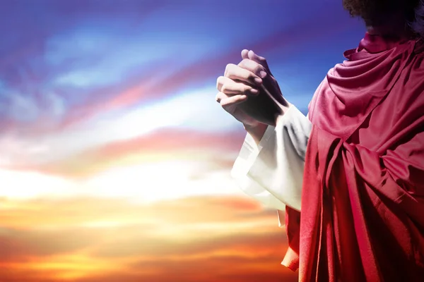 Jesus Christ raised hands and praying to god — Stock Photo, Image