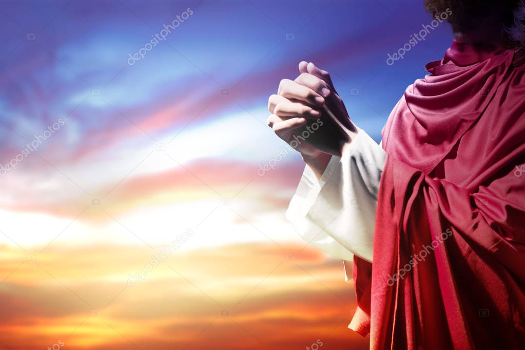 Jesus Christ raised hands and praying to god