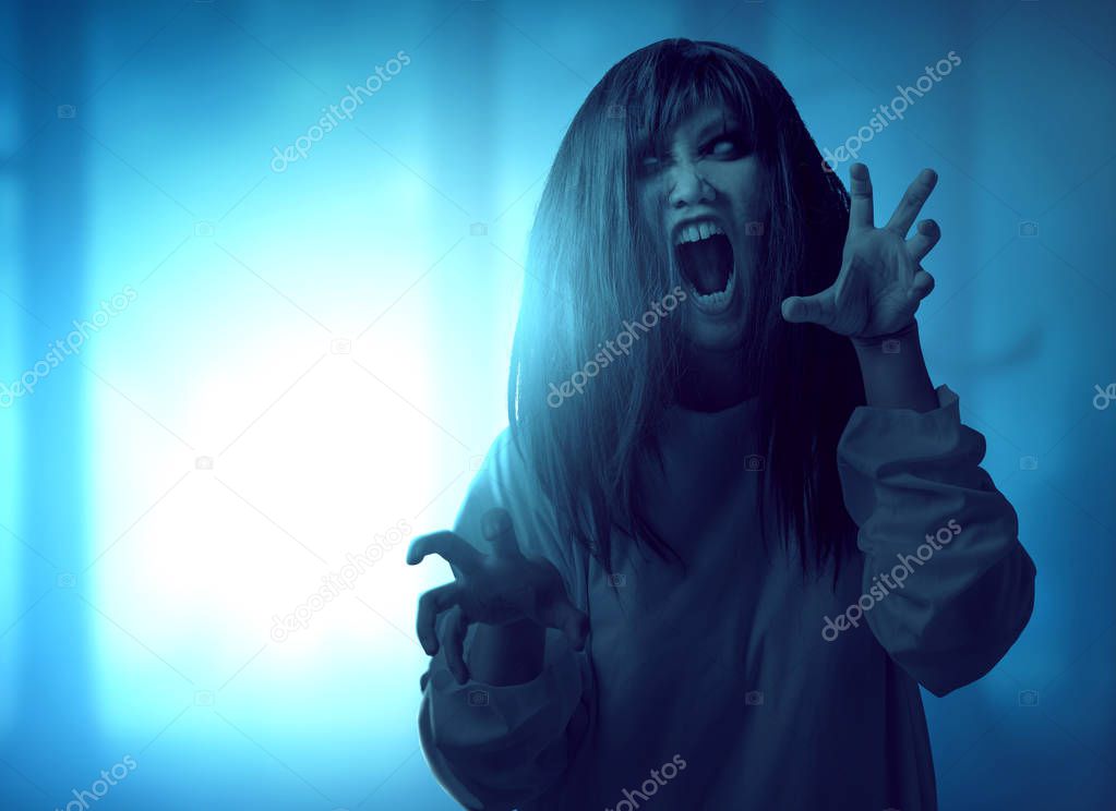 Scary ghost woman with blood and angry face with clawing hands s