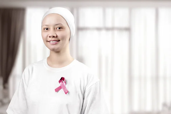 Asian woman in a white shirt with a pink ribbon on the home — Stock Photo, Image