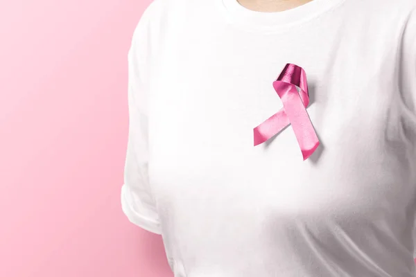 Mujer en camisa blanca con cinta rosa sobre fondo rosa —  Fotos de Stock