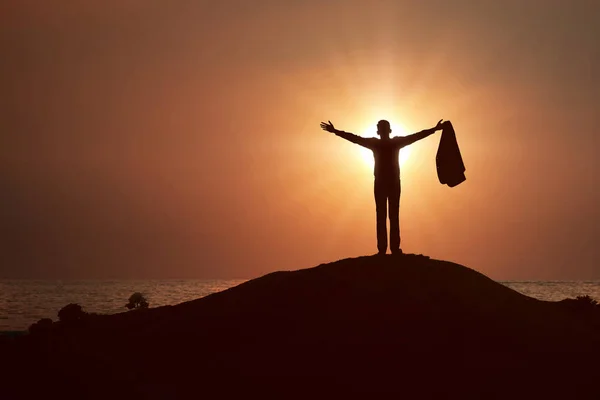 Silhouette of businessman raised hands and praying to god — Stock Photo, Image