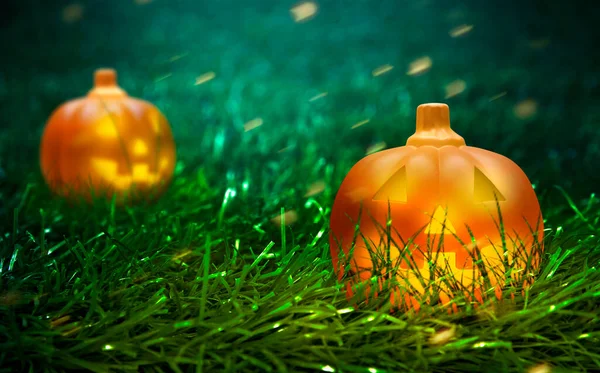 Jack-o-Lantern on the green grass with sparks in the meadow