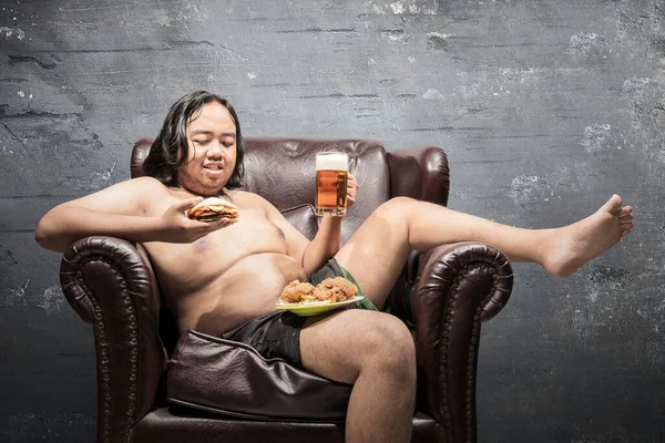 Asian Fat Man Lying Couch Eating Fast Food Home Junk — Stock Photo, Image